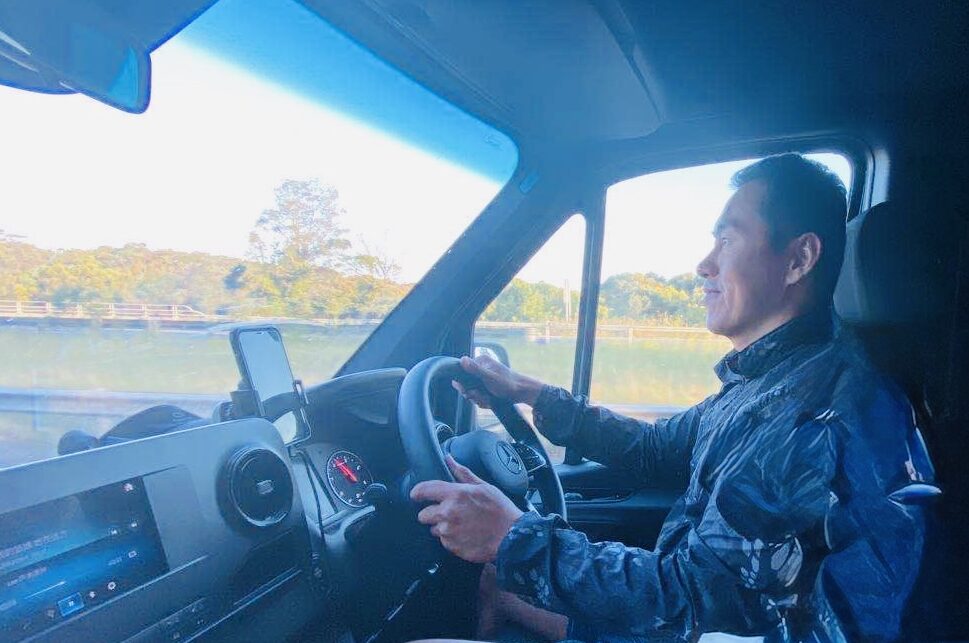 Leo driving a Mercedes Sprinter while guiding an Australia road trip