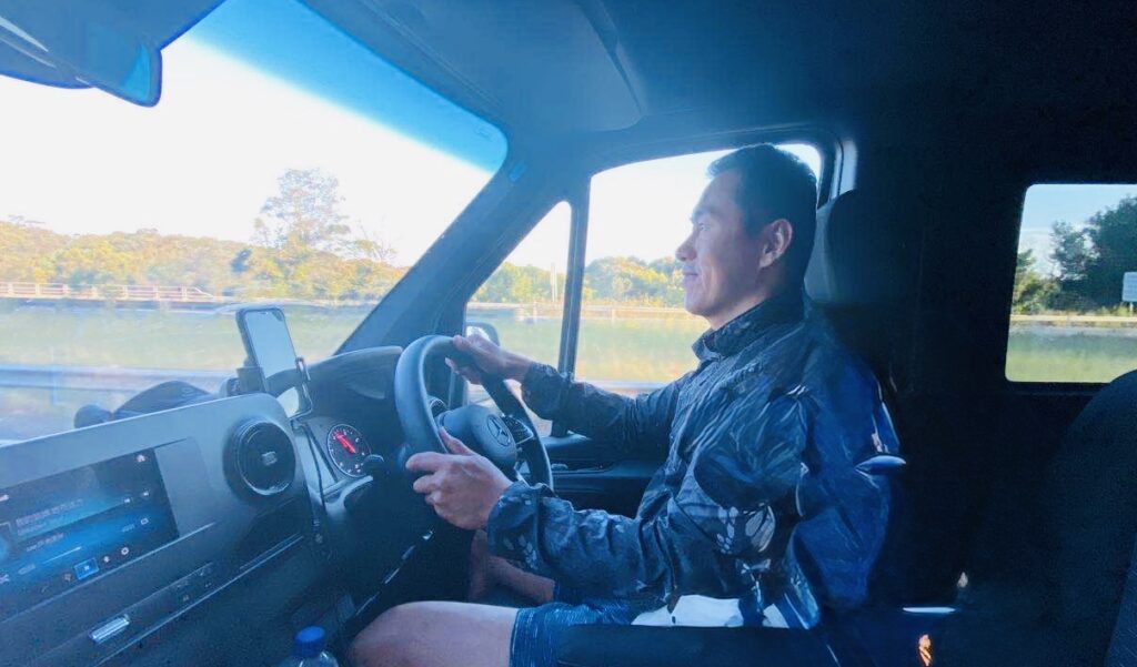 Leo driving a Mercedes Sprinter while guiding an Australia road trip