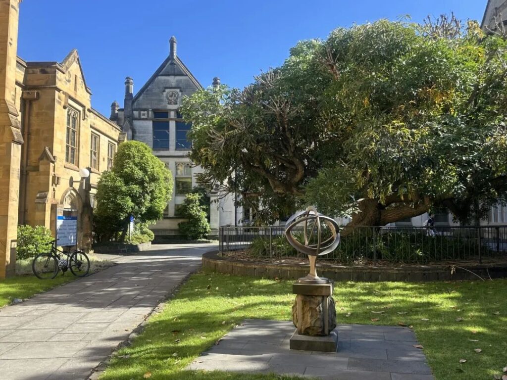 Campus walkway with elm trees and heritage architecture at University of Melbourne Parkville